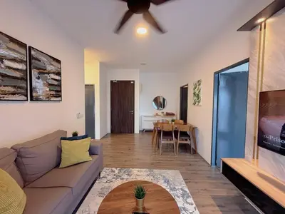 a living room with a couch and a table at 2BR with Balcony High Floor, Henna Residence Near LRT Sri Rampai & Wangsa Walk Mall in Kuala Lumpur