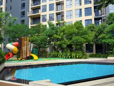 a pool with a playground in front of a building at 2BR with Balcony High Floor, Henna Residence Near LRT Sri Rampai & Wangsa Walk Mall in Kuala Lumpur