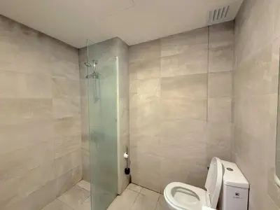 a bathroom with a toilet and a glass shower at 2BR with Balcony High Floor, Henna Residence Near LRT Sri Rampai & Wangsa Walk Mall in Kuala Lumpur