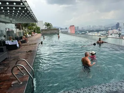 a group of people in a swimming pool on a building at Regalia KLCC Pavilion Ceylon Jalan Alor 8 PAX 2R2B in Kuala Lumpur