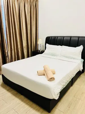 a bedroom with a bed with two towels on it at M City by Celestia Suites in Kuala Lumpur