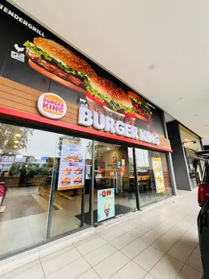 a burger king restaurant with a large sandwich on the facade at M City by Celestia Suites in Kuala Lumpur