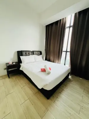 a bedroom with a bed with two towels on it at M City by Celestia Suites in Kuala Lumpur