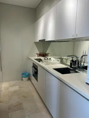 a kitchen with white cabinets and a sink at Skysuites Twin Tower Prime Location in Kuala Lumpur