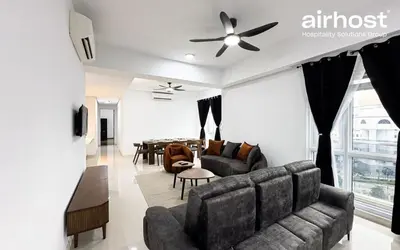 a living room with a couch and a table at MET 1 Residences Mont Kiara by Airhost in Kuala Lumpur