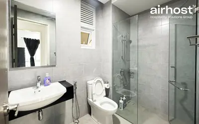 a bathroom with a toilet and a sink and a shower at MET 1 Residences Mont Kiara by Airhost in Kuala Lumpur