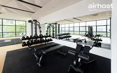 an empty gym with rows of chairs and machines at MET 1 Residences Mont Kiara by Airhost in Kuala Lumpur