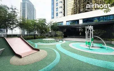 a park with a slide and a playground at MET 1 Residences Mont Kiara by Airhost in Kuala Lumpur