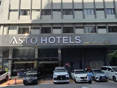a hotel with cars parked in front of it at Asto Hotel Kuala Lumpur in Kuala Lumpur