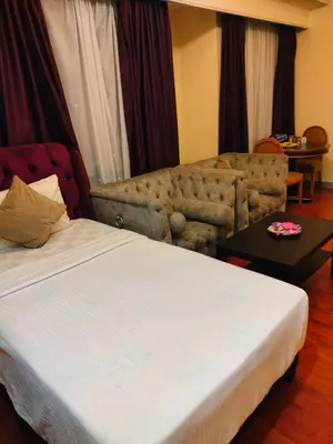 a hotel room with a bed and a couch at kl Dreamx service suite at times square in Kuala Lumpur