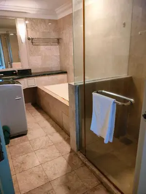 a bathroom with a shower with a white towel on a towel rack at kl Dreamx service suite at times square in Kuala Lumpur