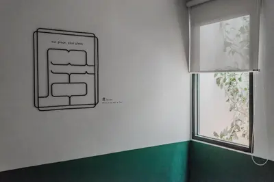 a sign on a wall next to a window at Swing & Pillows - Kentomen Hotel, Bamboo Hills in Kuala Lumpur
