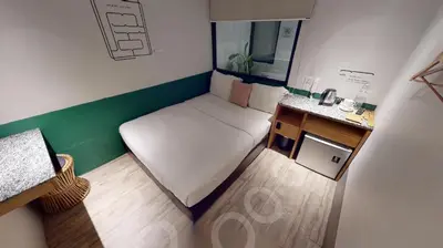 a small room with a small bed and a sink at Swing & Pillows - Kentomen Hotel, Bamboo Hills in Kuala Lumpur
