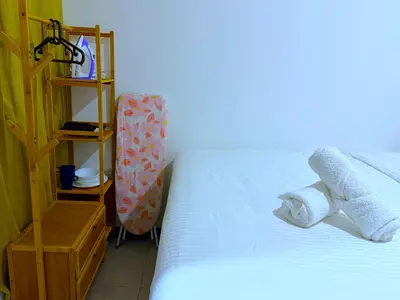a bedroom with a bed with two towels on it at Cozy unit By Rasbo Galaxy with LRT , Pool , KLCC in Kuala Lumpur