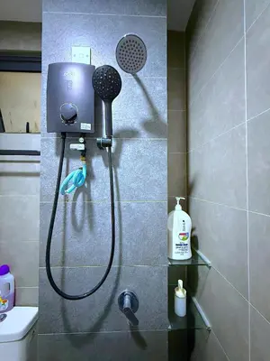 a shower in a bathroom with a blow dryer at Cozy unit By Rasbo Galaxy with LRT , Pool , KLCC in Kuala Lumpur
