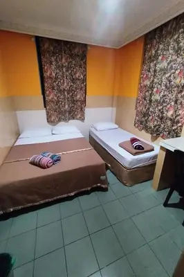 two beds in a room with two windows at 98 Inn BilikXpert at Chow Kit in Kuala Lumpur