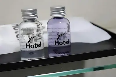 two bottles of alcohol sitting on a shelf at Hotel AL Amin in Kuala Lumpur