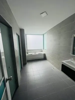 a large bathroom with a tub and a sink at Taragon Puteri Bintang KLCC View Studio Apartment in Kuala Lumpur
