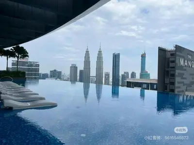 a pool on top of a building with a city skyline at Eaton Residence City Suites in Kuala Lumpur