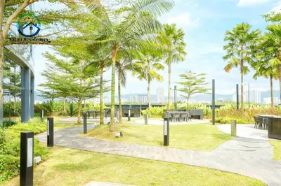 a park with palm trees and picnic tables at Eaton Residence City Suites in Kuala Lumpur