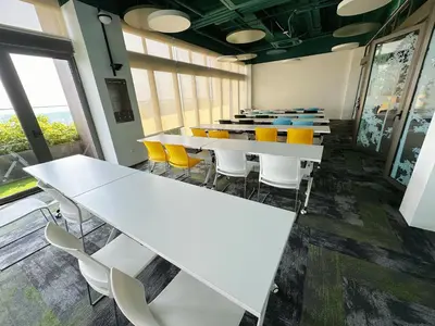 a conference room with white tables and yellow chairs at KL Sentral Monorail 4 pax Kuala Lumpur, Sky Pool Family Merdeka 118 Nice View in Kuala Lumpur