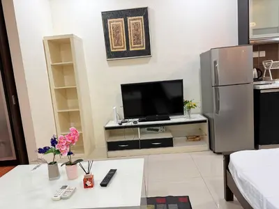 a living room with a flat screen tv on a counter at Taragon Putri Bintang in Kuala Lumpur