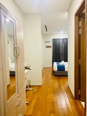 a room with a bedroom with a bed and a mirror at Kuala Lumpur Sky Suites KLCC in Kuala Lumpur