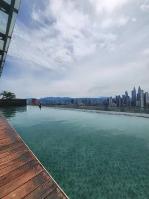 a large body of water with a city in the background at Infinity Pool Hostel KL in Kuala Lumpur