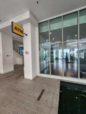 an entrance to a building with an atm sign on it at Infinity Pool Hostel KL in Kuala Lumpur
