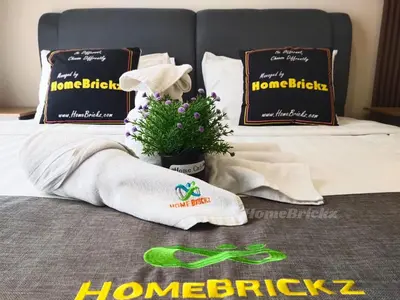 a bed with towels and a potted plant on it at Majestic Residence Suites KLCC by Homebrickz in Kuala Lumpur