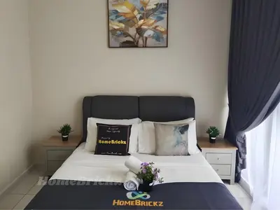 a bedroom with a bed with white sheets and pillows at Majestic Residence Suites KLCC by Homebrickz in Kuala Lumpur
