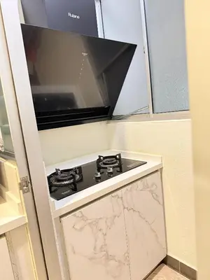 a kitchen with a stove and a microwave at RSJ Homestay at Setapak - 2 Room in Kuala Lumpur
