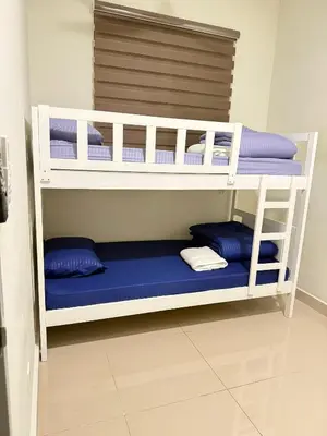 two bunk beds in a room with blue pillows at RSJ Homestay at Setapak - 2 Room in Kuala Lumpur