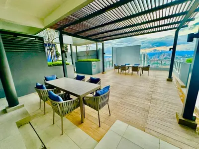 a room with a table and chairs on a building at Neu Suites by Serenity Luxe Suites in Kuala Lumpur