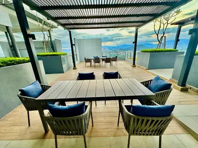 a patio with a table and chairs on a building at Neu Suites by Serenity Luxe Suites in Kuala Lumpur