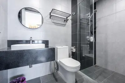 a bathroom with a toilet and a sink and a mirror at SV001 Maluri - Sunway Velocity - Cheras Stay in Kuala Lumpur