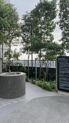 a park with a fountain in front of a fence at M Arisa Sentul City View Condo in Kuala Lumpur