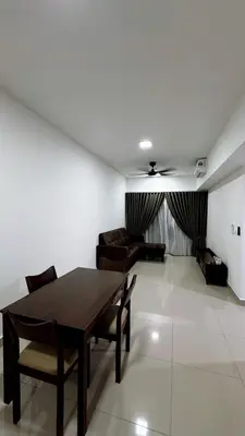 a living room with a wooden table and chairs at M Arisa Sentul City View Condo in Kuala Lumpur