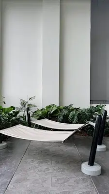 a hammock in the middle of a room with plants at M Arisa Sentul City View Condo in Kuala Lumpur