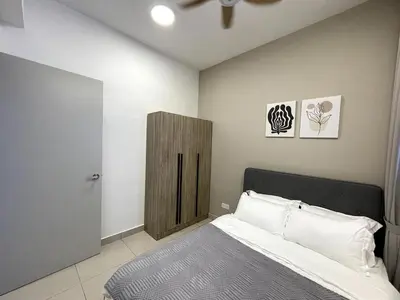 a bedroom with a bed and a wooden cabinet at Trion KL SkyLoft in Kuala Lumpur