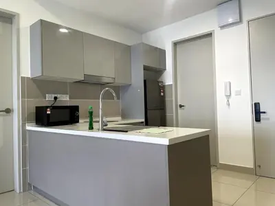 a kitchen with a counter with a sink and a microwave at Trion KL SkyLoft in Kuala Lumpur