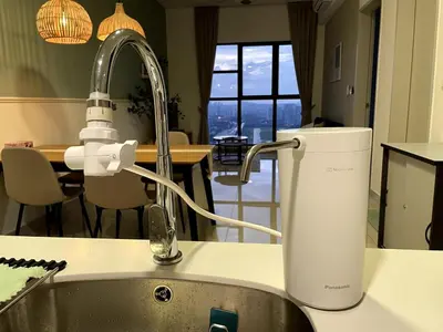 a kitchen sink with a faucet next to a kitchen at Trion KL SkyLoft in Kuala Lumpur