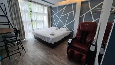 a bedroom with a bed and a chair in it at VG Homes in Kuala Lumpur