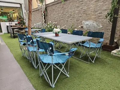 a table and chairs on the grass in a garden at VG Homes in Kuala Lumpur