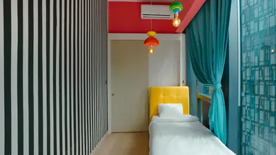 a room with a bed and a yellow chair at Star KLCC Comfort Suite 3-4pax in Kuala Lumpur
