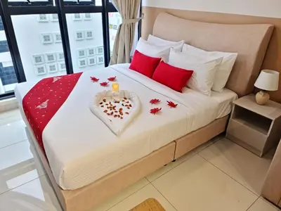 a bedroom with a heart shaped bed with a candle and red pillows at KLCC View Serviced Apartment at Majestic Residence Kuala Lumpur in Kuala Lumpur