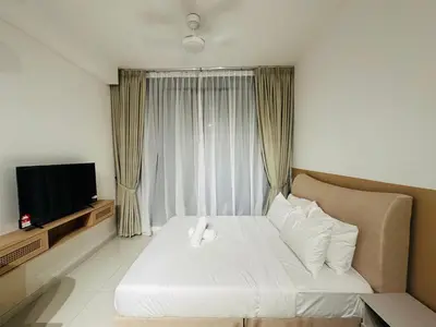 a hotel room with a bed and a television at KLCC View Serviced Apartment at Majestic Residence Kuala Lumpur in Kuala Lumpur