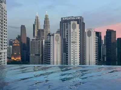 a view of a city skyline from a swimming pool at KLCC View Serviced Apartment at Majestic Residence Kuala Lumpur in Kuala Lumpur