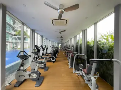a gym with rows of treadmills and exercise bikes at Vortex Suites KLCC By GuestHouse in Kuala Lumpur