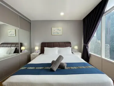 a bedroom with a bed and a large window at Vortex Suites KLCC By GuestHouse in Kuala Lumpur